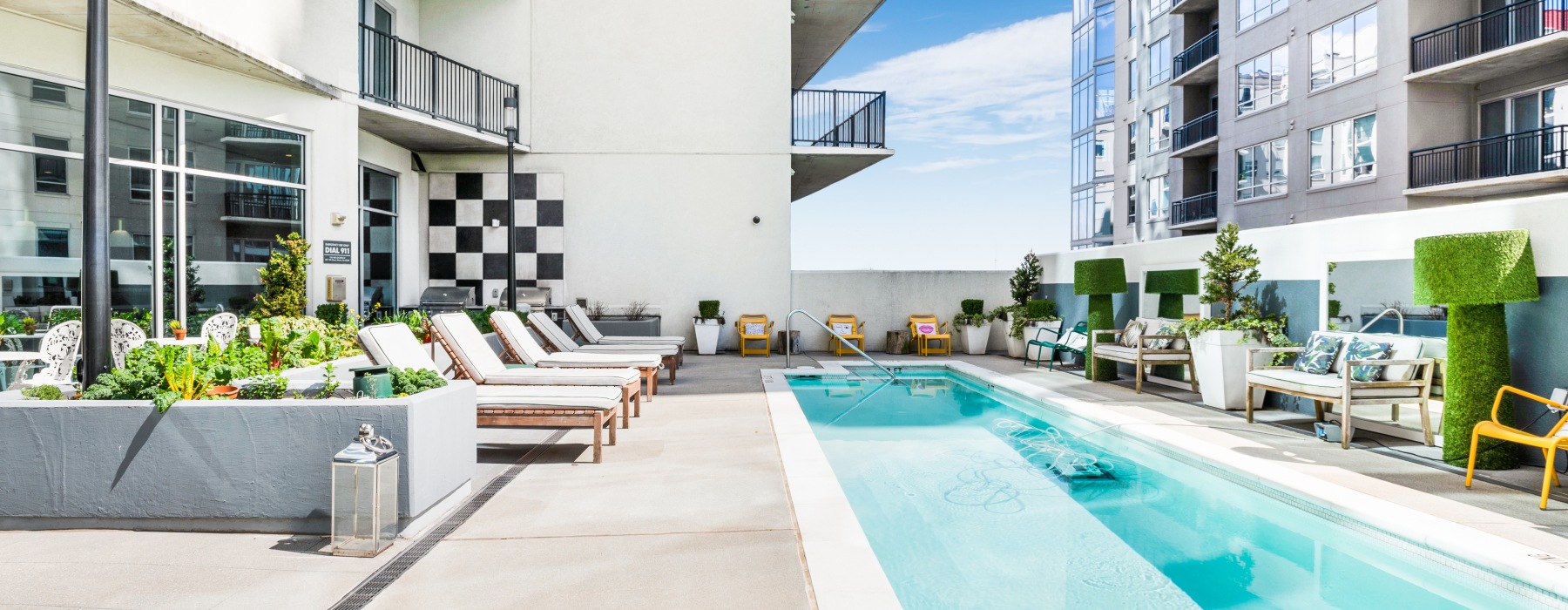 Resort style swimming pool with modern lounge furniture
