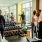 People lifting weights and using the large wall-to-wall style mirror in the fitness room at The Registry on the Park