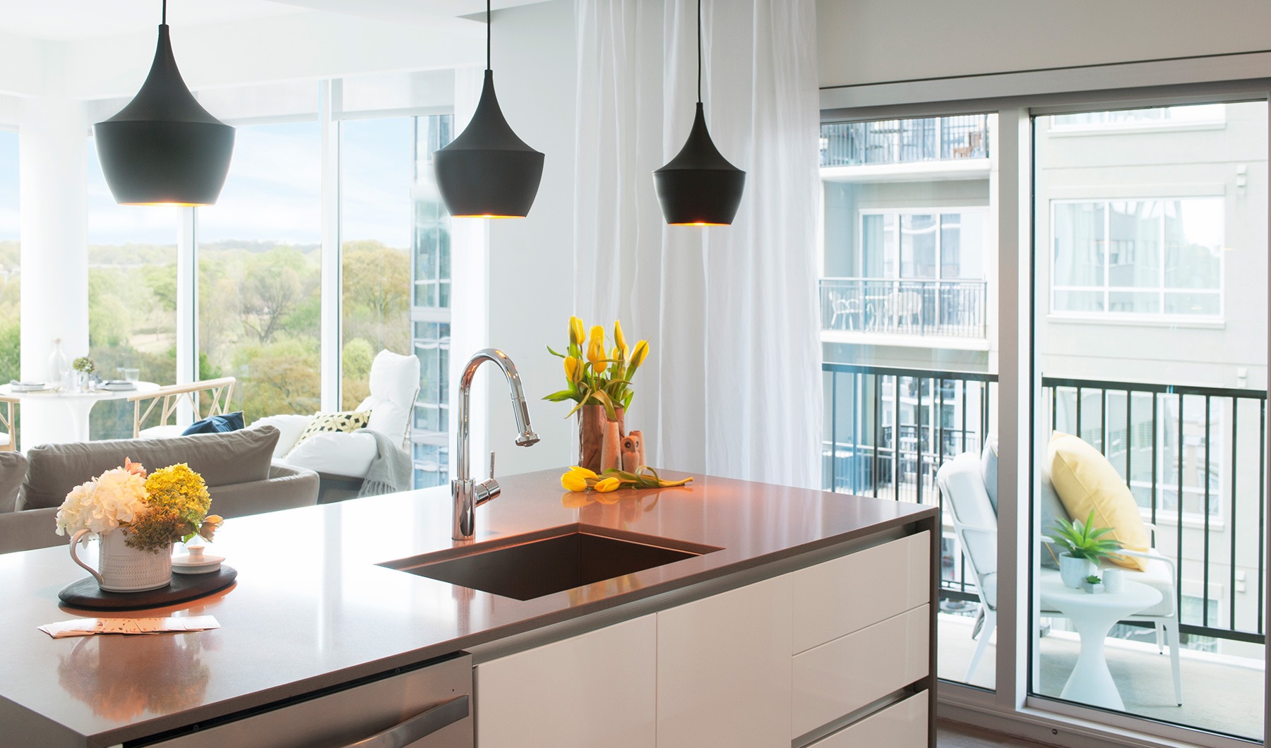 Modern pendant lighting and kitchen islands in apartments at The Registry on the Park